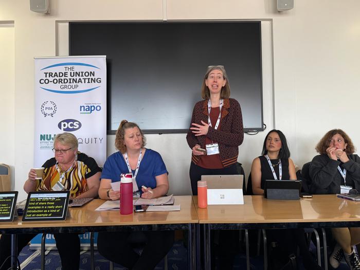 Five trade unionists behind a desk as part of a panel.