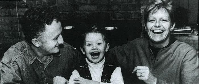 Black-and-white photo of Veronica Guerin laughing alongside her family.