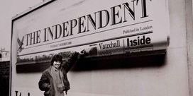 Brian Harris points to a billboard displaying the frontpage of The Independent.