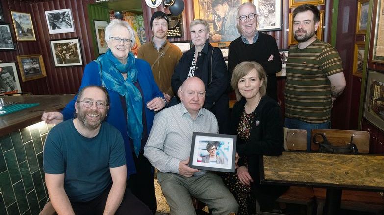 NUJ Belfast and District branch members unveil a photo of their colleague Lyra McKee at The Reporter bar in Belfast.