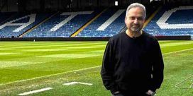 Barnie Choudhury standing in the Oldham FC stadium.